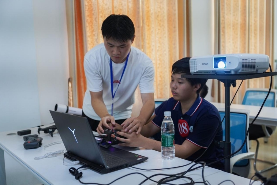 beat365中文唯一官网信息工程学院学生正在指导研学团成员操控无人机。